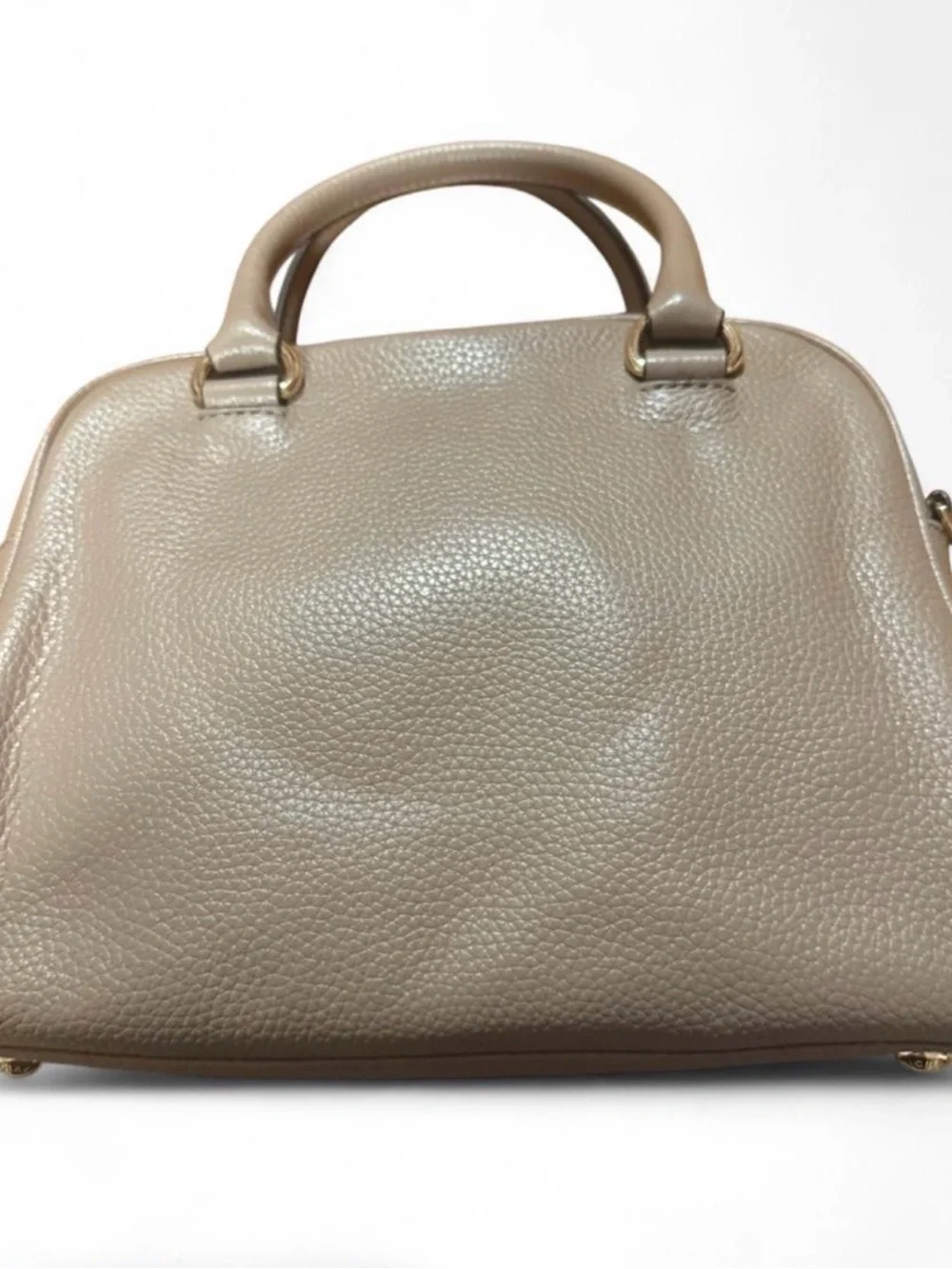 Michael Kors Knox Satchel featuring a prominent tassel and gold-tone hardware